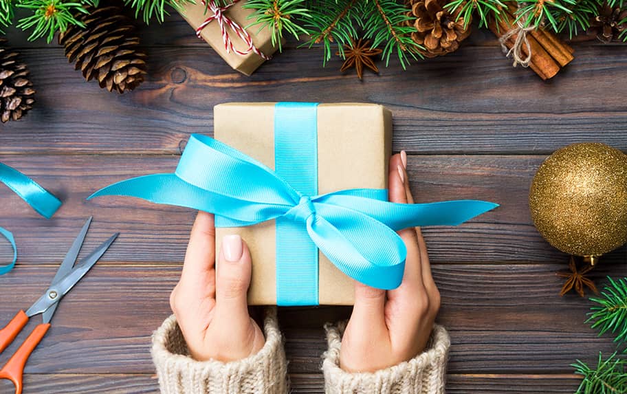 Wrapped Holiday Gift on Wooden Table