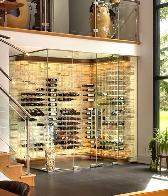 Elegant wine cellar surrounded by glass walls.