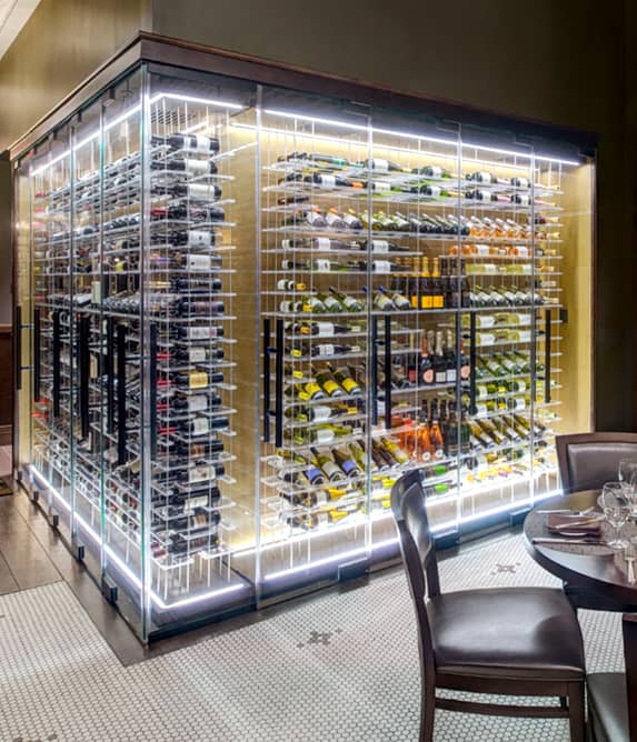 Large square wine cellar enclosed with glass.