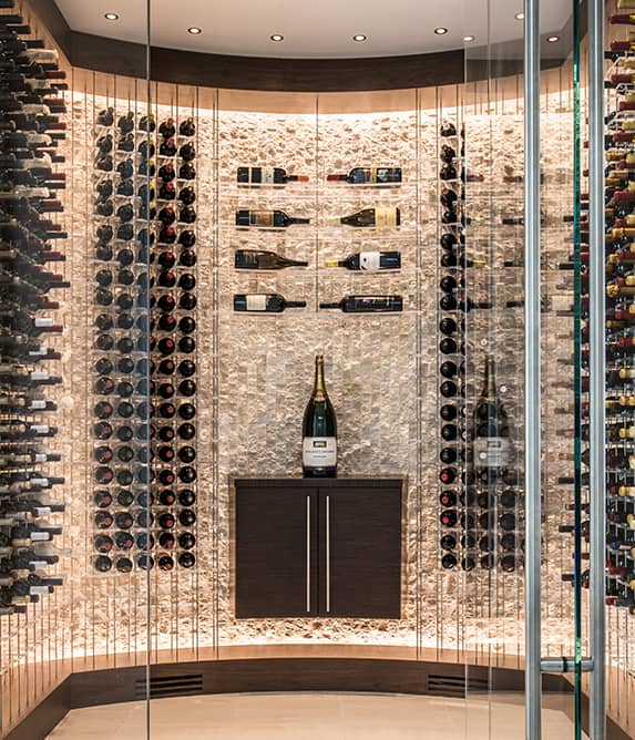 Floating wine bottles in a glass enclosed wine cellar.