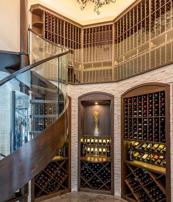 Spiral staircase surrounded by wood wine cellars.